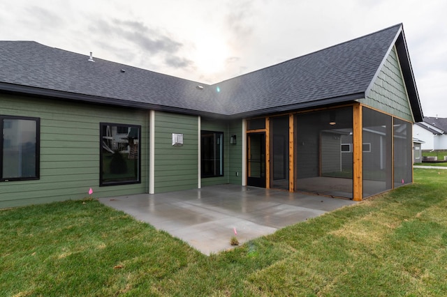 rear view of house with a yard and a patio area