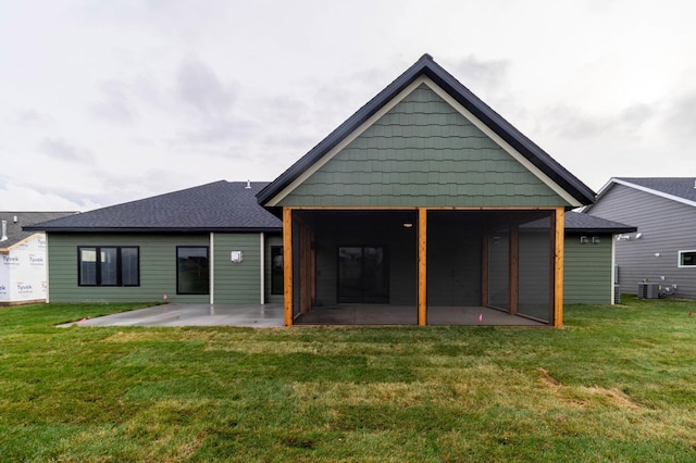 back of house with central AC unit, a yard, and a patio