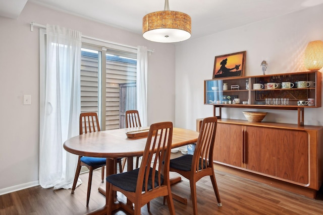 dining space featuring dark wood-type flooring