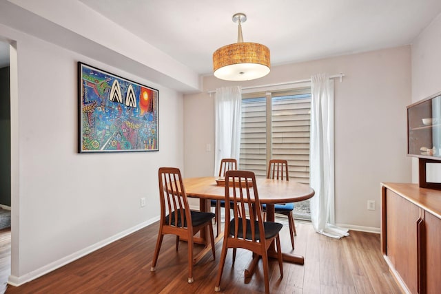 dining area with wood-type flooring