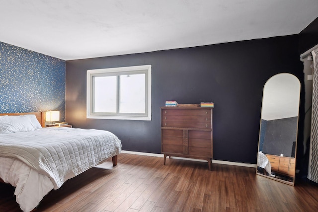 bedroom with dark wood-type flooring