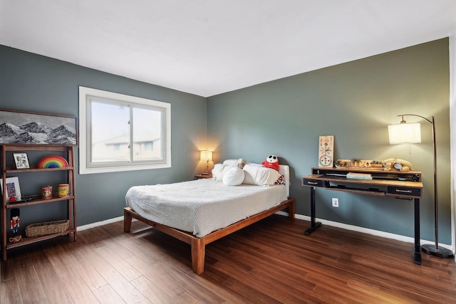 bedroom with dark hardwood / wood-style floors