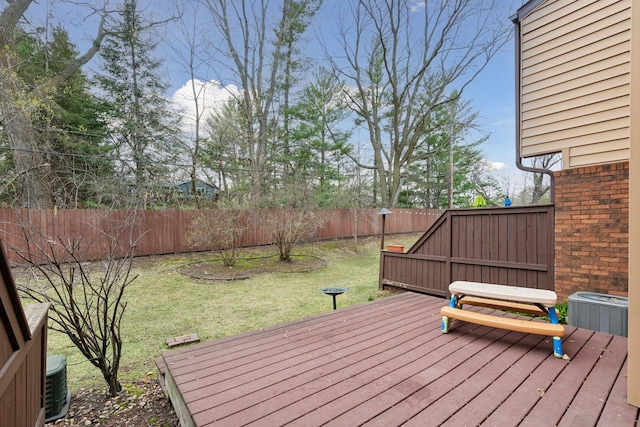 wooden deck featuring a lawn and central AC unit