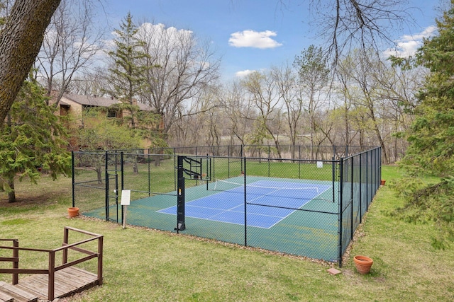 view of sport court featuring a yard