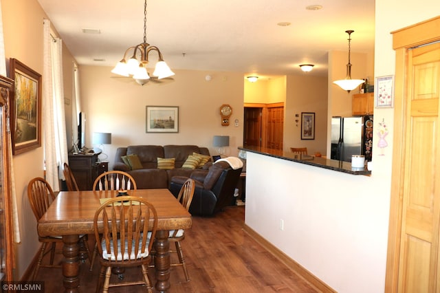 dining room with a chandelier and dark hardwood / wood-style flooring