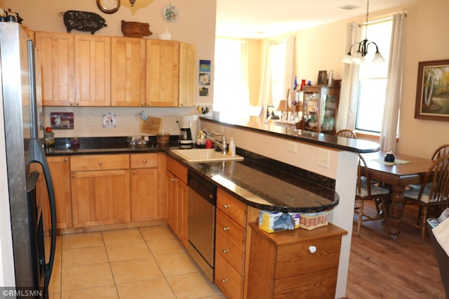 kitchen featuring pendant lighting, sink, kitchen peninsula, stainless steel appliances, and light tile patterned floors