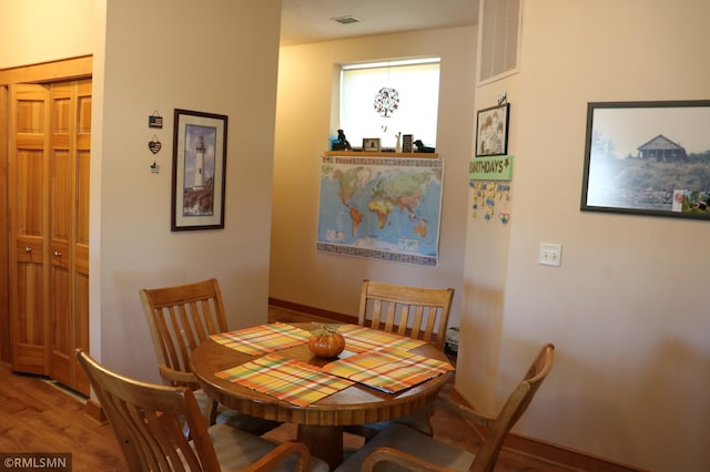 dining area with hardwood / wood-style floors