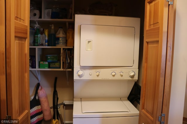 laundry room with stacked washing maching and dryer