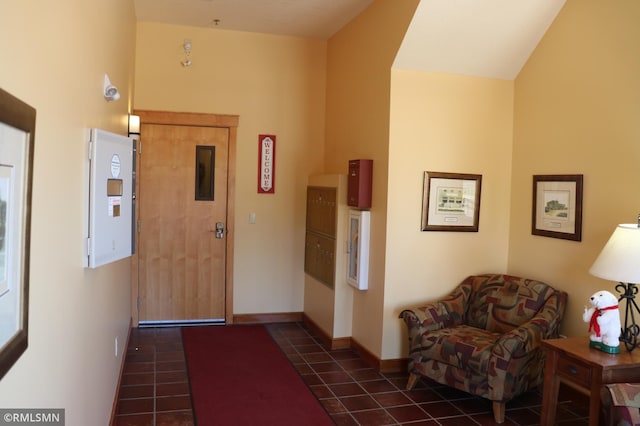 tiled foyer with lofted ceiling