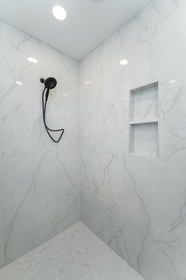 bathroom with tiled shower