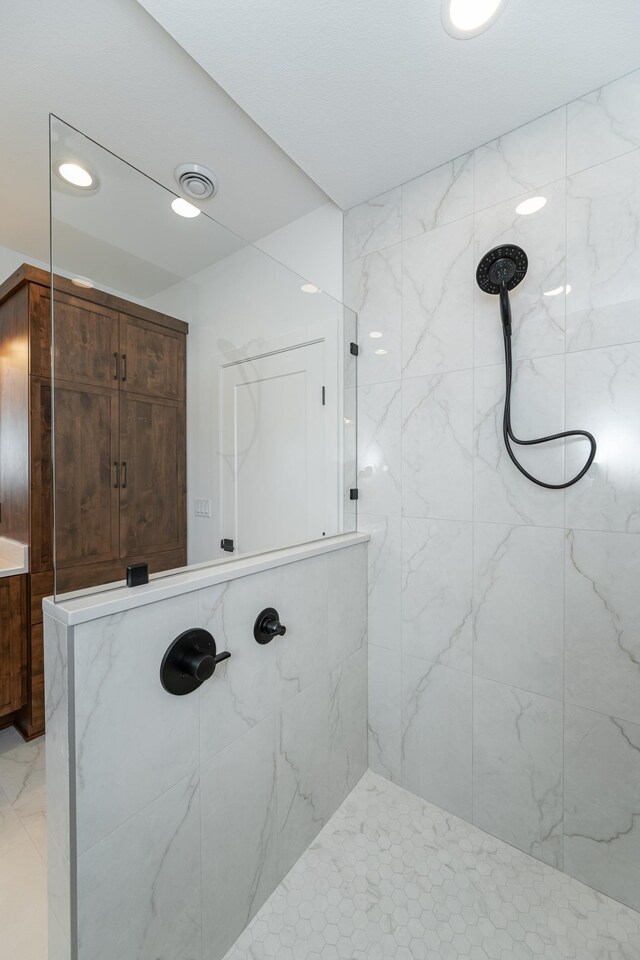 bathroom with tiled shower