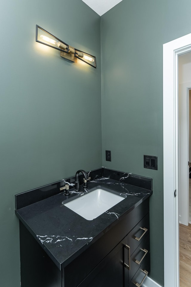 bathroom with hardwood / wood-style flooring and vanity