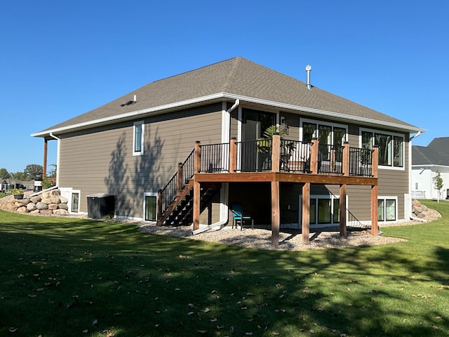 back of house featuring a lawn and a wooden deck