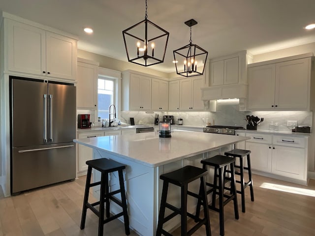 kitchen featuring a notable chandelier, white cabinetry, light hardwood / wood-style flooring, and high end fridge