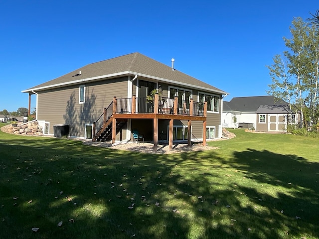 back of house featuring a lawn, a deck, and central air condition unit