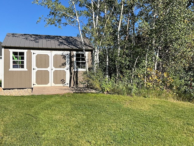 view of outbuilding with a yard