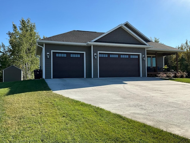 view of front of house featuring a garage, a porch, and a front lawn