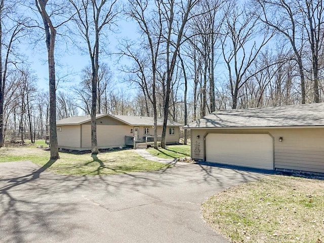 7983 County Road 127, Brainerd, MN 56401 - view of side of home with a garage, driveway, and a lawn