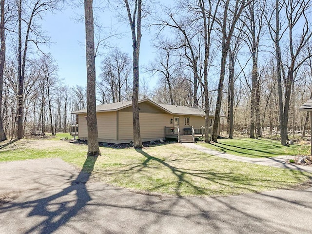 7983 County Road 127, Brainerd, MN 56401 - view of side of home featuring a deck and a lawn