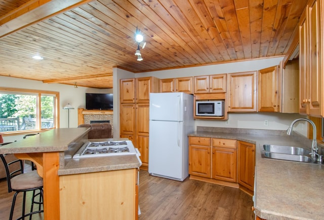 7983 County Road 127, Brainerd, MN 56401 - kitchen with white appliances, a sink, wood ceiling, a kitchen island, and a fireplace