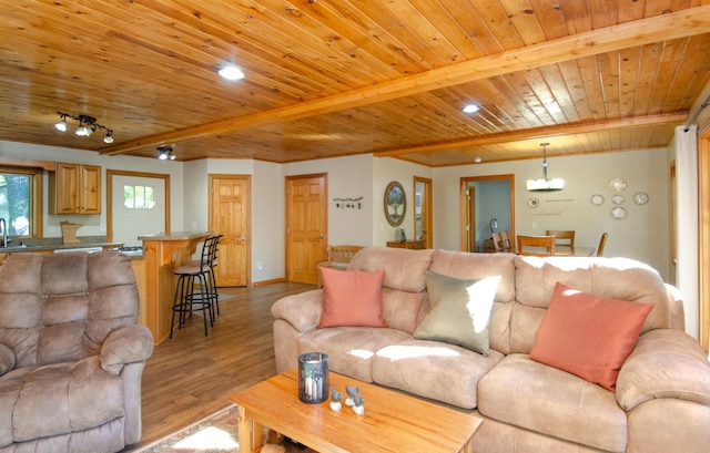 7983 County Road 127, Brainerd, MN 56401 - living area with wooden ceiling, light wood-style floors, a chandelier, beam ceiling, and baseboards