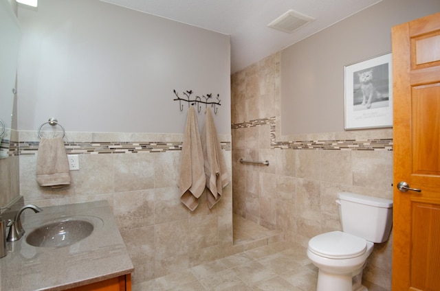 7983 County Road 127, Brainerd, MN 56401 - full bath featuring tile walls, vanity, toilet, walk in shower, and a wainscoted wall