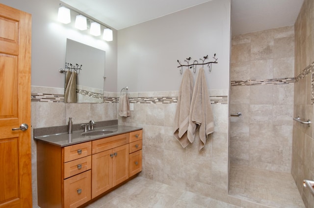 7983 County Road 127, Brainerd, MN 56401 - bathroom with vanity, a tile shower, tile walls, and wainscoting