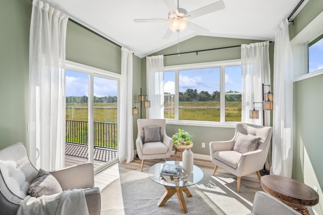 sitting room featuring ceiling fan, lofted ceiling, and light hardwood / wood-style flooring