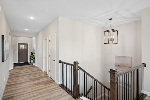 interior space with a notable chandelier and light hardwood / wood-style floors