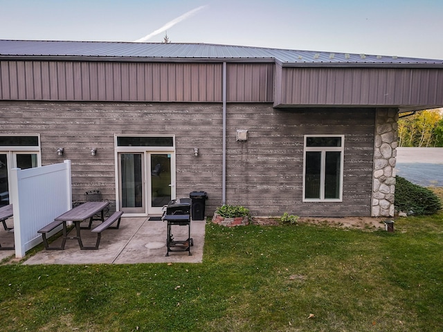 rear view of house featuring a patio and a yard