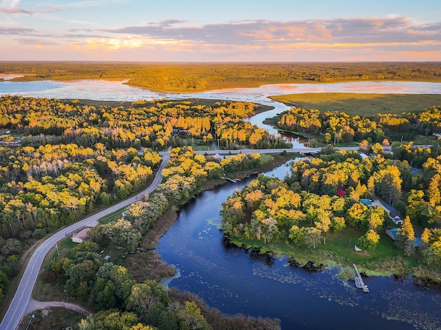 aerial view at dusk with a water view