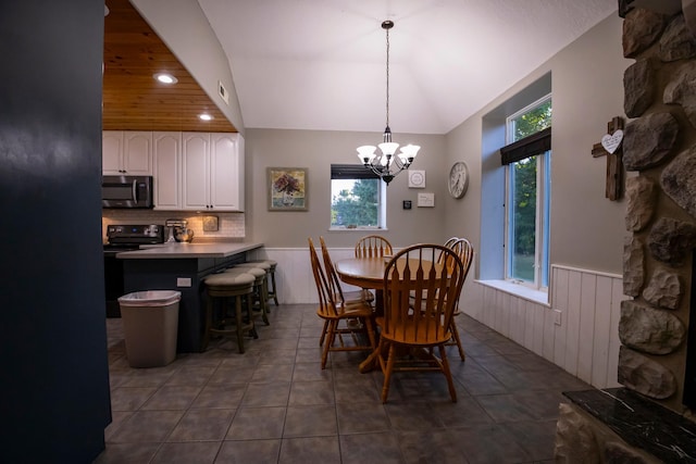 tiled dining area with an inviting chandelier and plenty of natural light