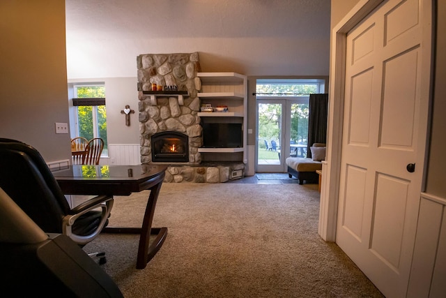 carpeted office space featuring a fireplace and a wealth of natural light