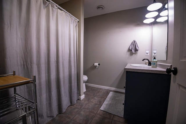 bathroom with vanity, tile patterned flooring, and toilet