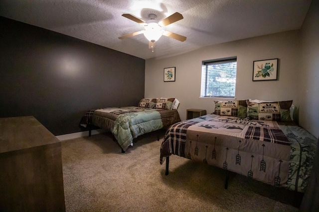 bedroom featuring ceiling fan, a textured ceiling, and carpet flooring