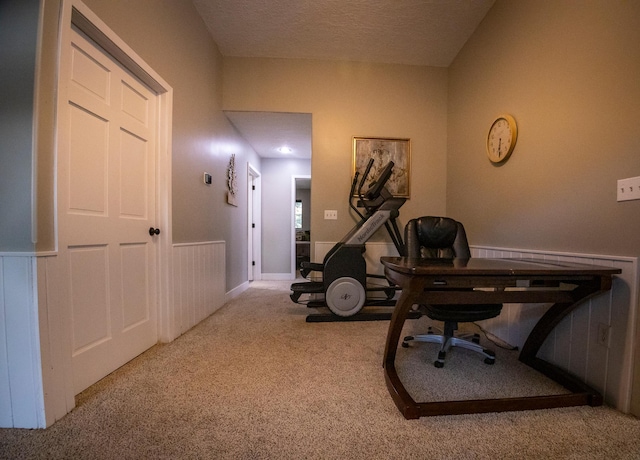 carpeted office featuring a textured ceiling