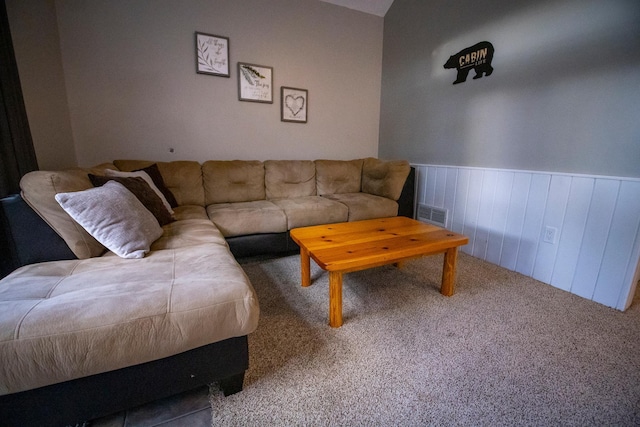 living room with wooden walls and carpet flooring