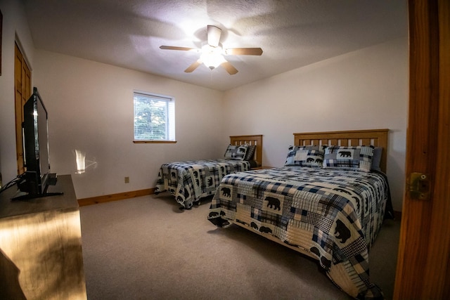 bedroom featuring ceiling fan, a textured ceiling, and carpet flooring