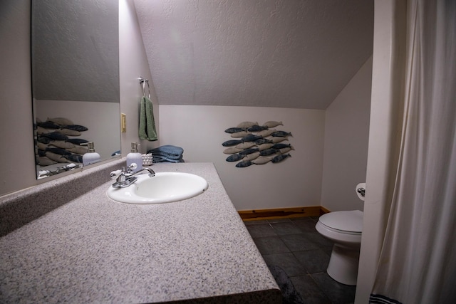 bathroom featuring tile patterned flooring, vaulted ceiling, toilet, and vanity