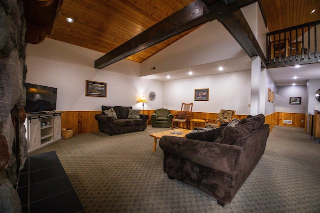 living room with high vaulted ceiling, a fireplace, beamed ceiling, carpet, and wooden walls