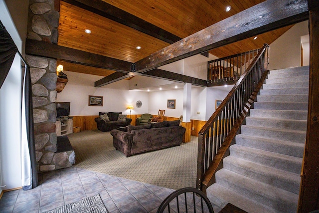 interior space with beamed ceiling, wooden walls, wooden ceiling, and tile patterned floors