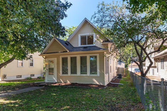 view of front of home featuring central AC unit and a front lawn