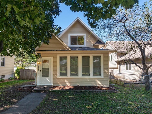 rear view of property featuring a yard