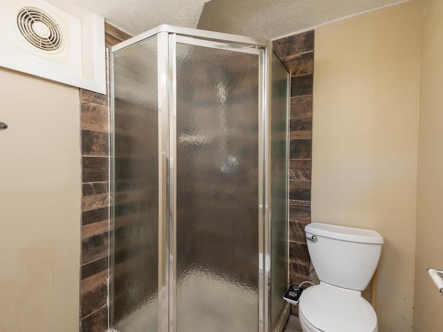 bathroom with toilet and an enclosed shower