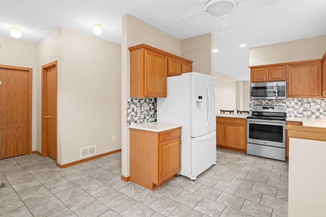 kitchen with appliances with stainless steel finishes, backsplash, and ceiling fan