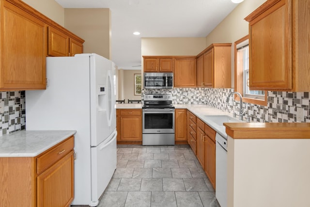 kitchen featuring backsplash, sink, a healthy amount of sunlight, and appliances with stainless steel finishes