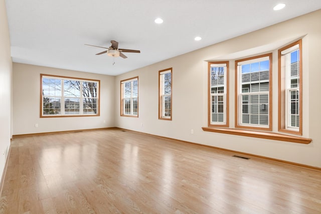 empty room featuring ceiling fan and light wood-type flooring