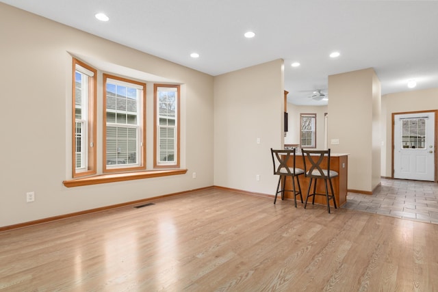 living room with ceiling fan and light hardwood / wood-style floors