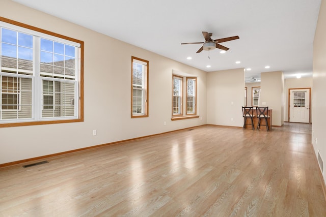 unfurnished living room with ceiling fan, plenty of natural light, and light wood-type flooring