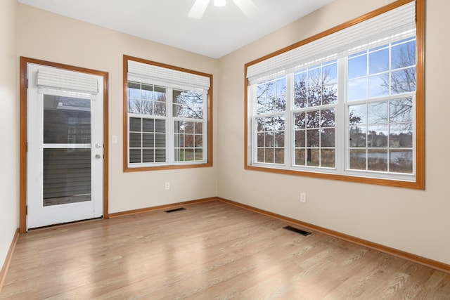 spare room featuring ceiling fan and light wood-type flooring